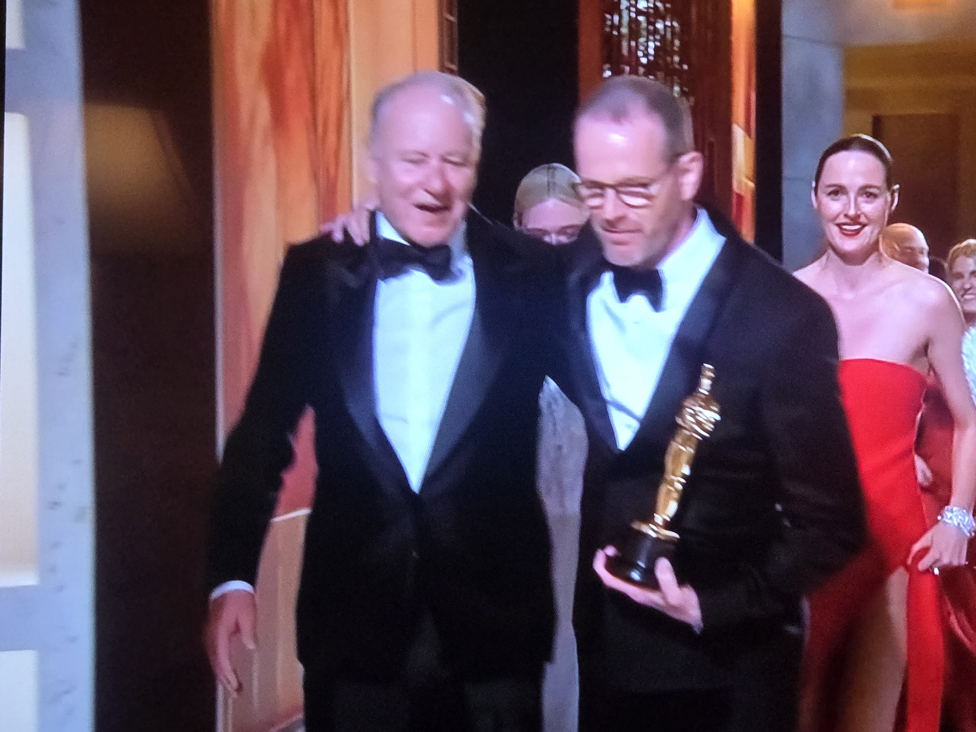 Winners celebrating backstage with Oscar statuette